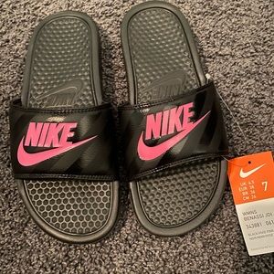 Black and pink Nike slides